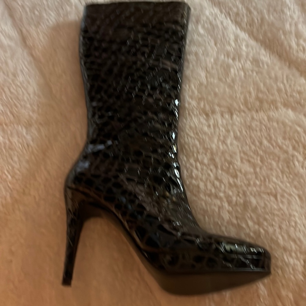 Brown patent leather high heeled platform knee high boot.